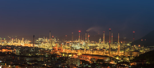 Night oil refinery, fuel manufacturer with city.