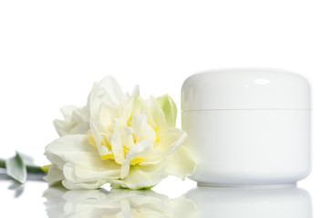 Fototapeta na wymiar Jar of beauty cream with flowers isolated on white background