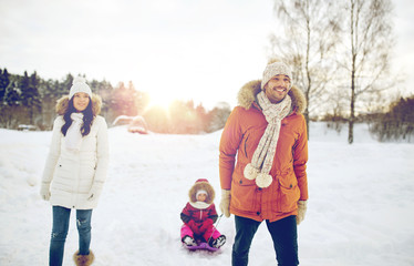 Fototapeta na wymiar happy family with sled walking in winter outdoors
