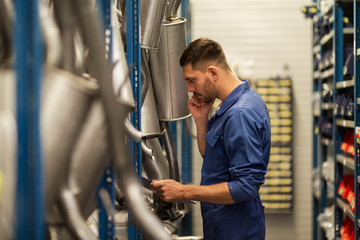 auto mechanic with clipboard at car workshop