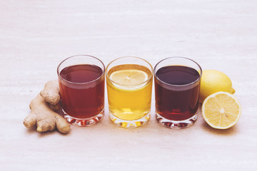drinks of different colours and textures in glass cups on table on white background. A place for a label. Copyspace