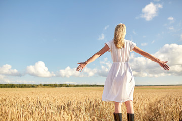 Fototapeta na wymiar happy young woman in white dress on cereal field