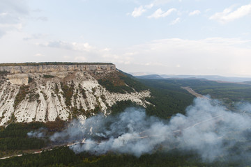 Views of countryside, mountain and forest in valley with clouds