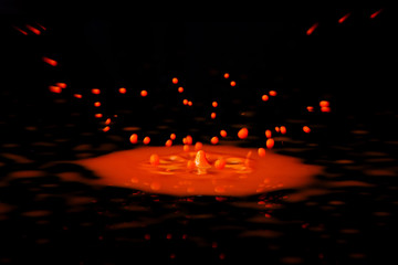 Paint drop splashing on black a background