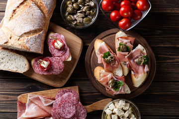 Obraz na płótnie Canvas Spanish tapas with slices jamon serrano, salami, olives and chee
