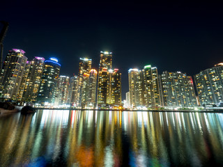 Night view of several buildings over the city's marine harbor in Busan