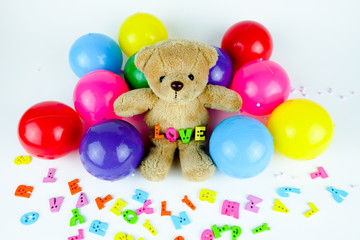 Brown bear doll with colorful ball and letters 