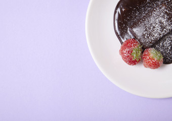 A hot chocolate fudge cake dessert on a pastel purple background forming a page border