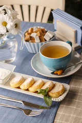 breakfast cheese cakes with tea on a table in a restaurant