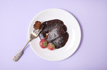 A chocolate fudge cake dessert on a pastel background
