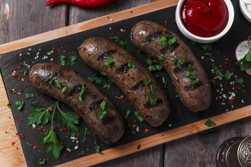 homemade cooked sausages fried on a grill beef