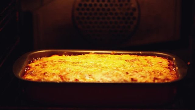 Baked lasagna in the oven. Open the oven and close. 1920x1080