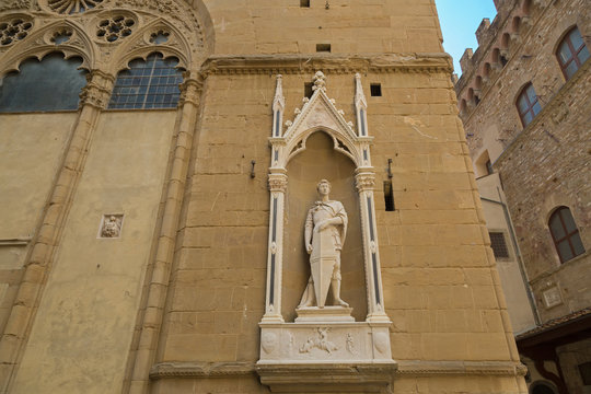 Bronze statue of Saint George (Guild of Armourers and Swordmakers) by Donatello, detail of Orsanmichele church exterior with 1 of 14 external niche figures in Florence, Italy