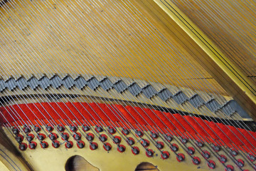 system mounting strings on an old piano closeup