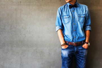 Men's casual outfits standing over gray grunge background with space, beauty and fashion concept