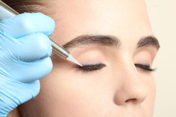 Cosmetologist making permanent makeup, close up - obrazy, fototapety, plakaty