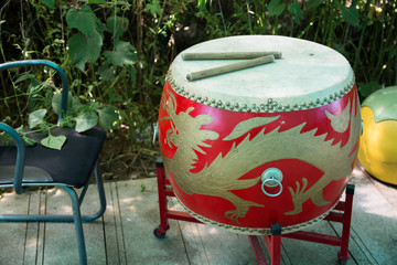 Red drum with asian motifs on the base.