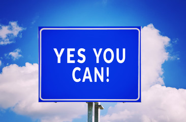 Yes You Can! road sign with cloud background