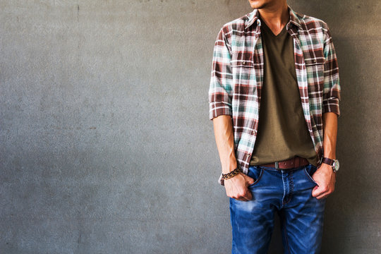 Men's casual outfits standing over gray grunge background with space, beauty and fashion concept