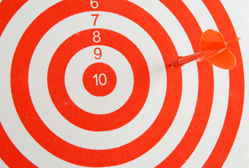 Close up of red and white shooting target and arrow