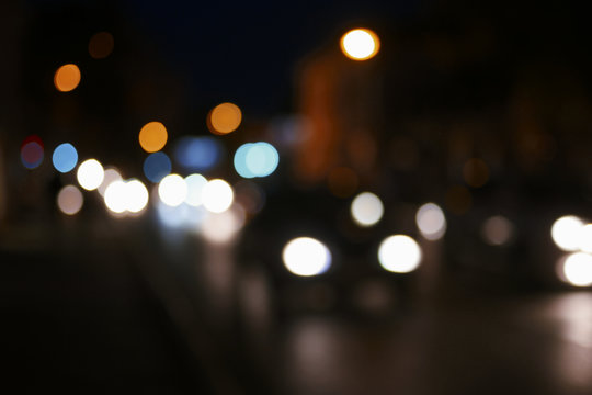 Vintage tone blur image of cars with bokeh lights traffic jam in night time for background