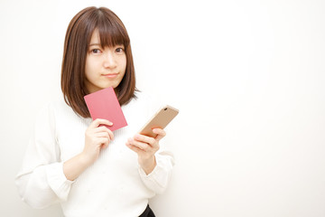 Young woman holding her passport with smile