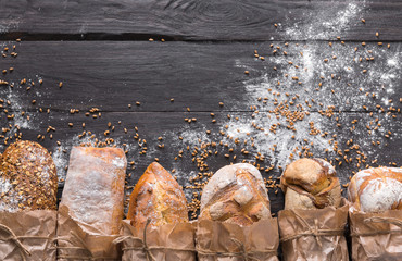 Bread bakery background. Brown and white wheat grain loaves composition