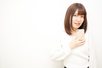 Young woman using a smart phone with smile