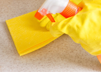 Hand in rubber glove cleans a new kitchen