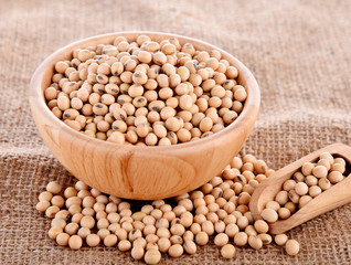 Soybeans in wood cup sackcloth background