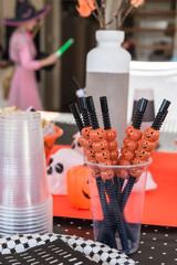 halloween decor in the foreground, with child in the costume in