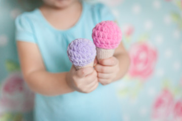 Little girl hands with a knitted toys
