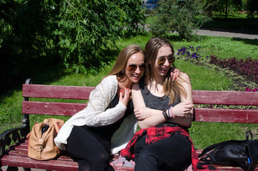 Two girlfriends resting in the park