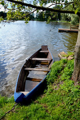 old wooden blue boat near resort lake coast
