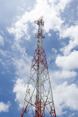 Mobile phone towers over white cloud and blue sky in rural areas