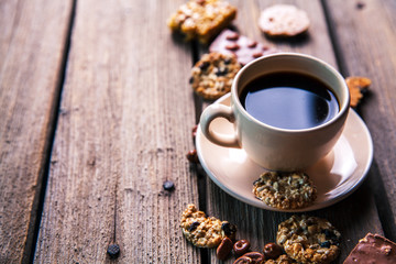 cup of coffee with a delicious chocolate and cookies on a wooden background - Powered by Adobe