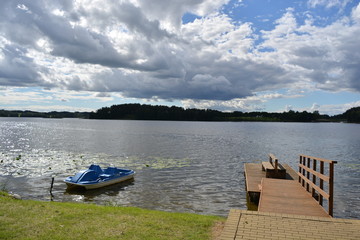 Obraz premium lake landscape with boat ant wooden bridge