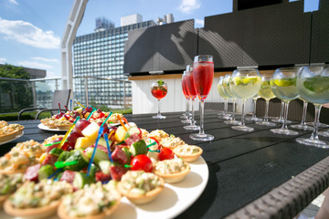 Set of canapes and cocktails on table at restaurant summer terra
