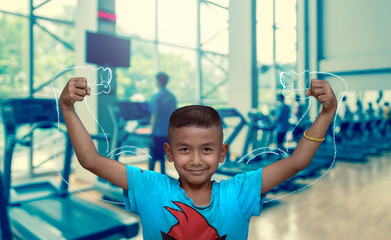 Asian strong children on Abstract blurred photo of fitness gym b