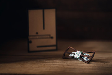 Wooden butterfly with a white cloth lying on a wooden table