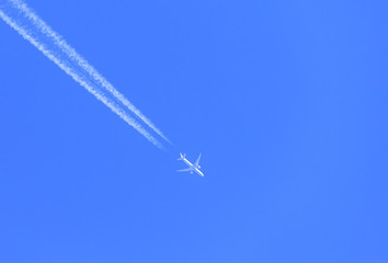 the plane flies on blue sky background