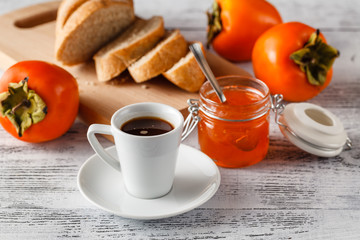 cup of coffee with apricot jam and bread