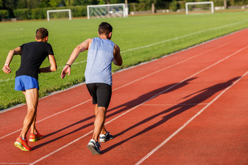 Obraz premium Active strong men in sportswear running on sammer sunny day