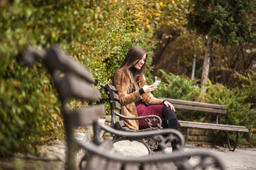 Woman texting in the park