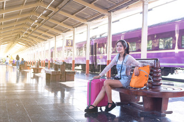 Backpack and camera at the train station with a traveler