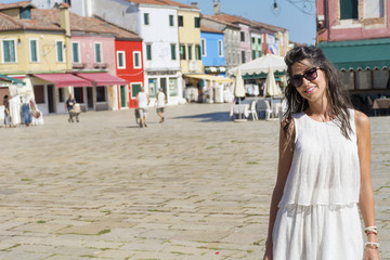 beautiful tourist woman with white dress walking in Burano ,Italy