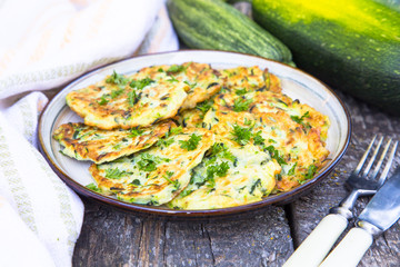 Squash and zucchini fritters on old wooden table