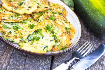 Squash and zucchini fritters on old wooden table