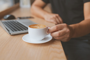 White coffee cup in focus.