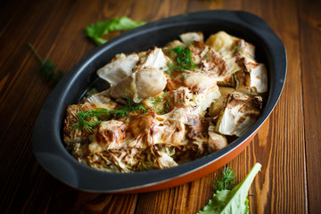 baked chicken legs with pieces of cabbage